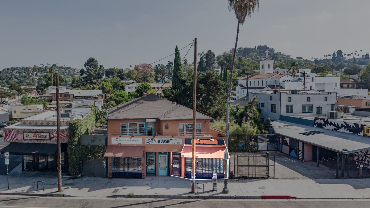 Elevated view of the terracotta building with a white outline around the right-hand ground-floor storefront only — the marketed 3815 suite — leaving 3817, the upper floor, and neighboring buildings outside the box.